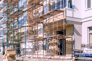 finishing the facade of a residential building using scaffolding