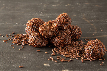 Brigadeiro (Brigadeiro) Traditional Brazilian sweet. Chocolate candies on dark background.