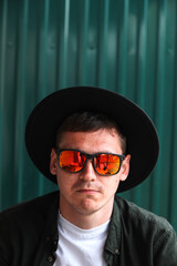 Smiling fashion man. Portrait of handsome smiling stylish hipster lambersexual model. Man dressed...