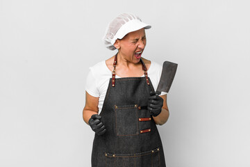 middle age woman looking unhappy and stressed, suicide gesture making gun sign. butcher concept