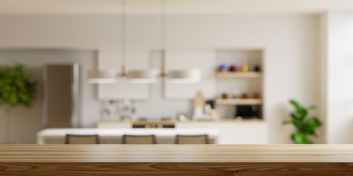 Wooden table top on blur kitchen room background,Modern Contemporary kitchen room interior.