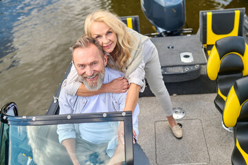 A mature couple having a weekend on a river and looking happy