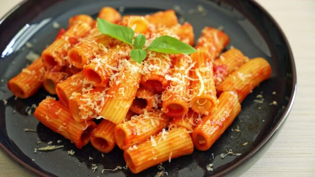 Rigatoni pasta with tomato sauce and cheese - traditional Italian pasta
