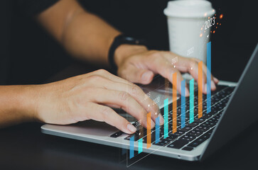 Fototapeta premium Business Analysis, Economic Growth, Finance with Virtual Graphs and Charts 2023.businessman using modern computer technology.