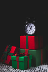 Waiting for the new year. Clock with an alarm clock and a gift.