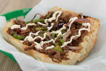 Tradional delicious philly cheesesteak sandwich loaded with all the favorites and presented on an open face