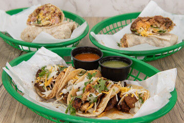 Loaded tacos are featured on this table full of delicious Mexican cuisine favorites served in a fast food basket