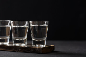 Vodka in a shot glass on black background