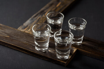Vodka in a shot glass on black background
