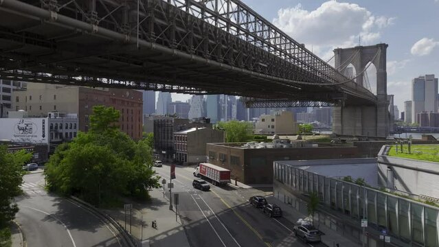 wide shot rising from Dumbo to view of Brooklyn Bridge and NYC view
