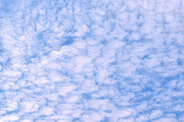 The blue sky was filled with many white clouds.