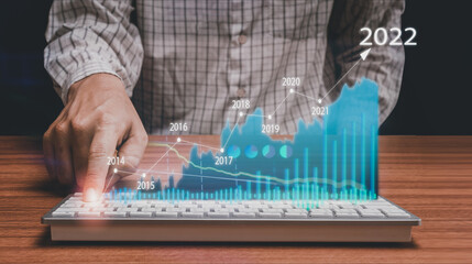 Man hands are using a computer keyboard to business  Charts stock   of financial instruments with...