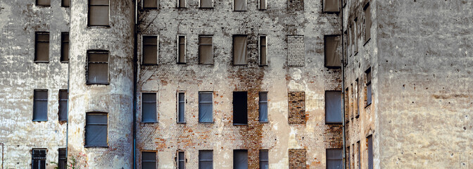 Background of the facade of an old brick house with windows. abandoned house