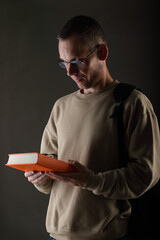 young man holding a book