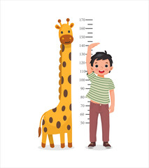 Cute Little boy measuring height of his growth on the background of wall with giraffe - obrazy, fototapety, plakaty