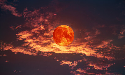 blood moon concept of a red full moon in black sky with cloud.