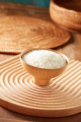 Raw rice in wooden bowl