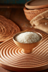 Raw rice in wooden bowl