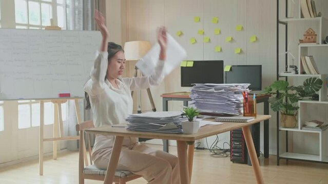 Pressure Asian Woman Throw Away The Paper While Working Hard With Documents At The Office
