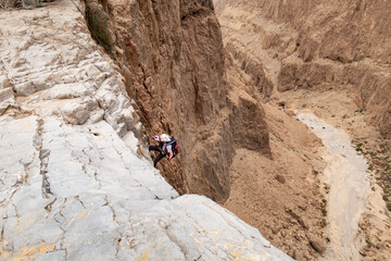 Experienced athlete on Israel Independence Day starts descending with equipment for rappel in...