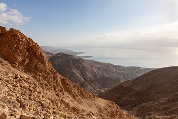 Obraz premium Sunrise over the Dead Sea near mountains of stone desert near the Khatsatson stream, on the Israeli side of the Dead Sea, near Jerusalem in Israel