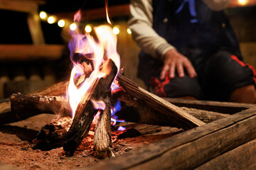 Close-up of flames from bonfire wood burning in dark in night campfire