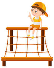 Boy sitting on climbing rope wall net playground