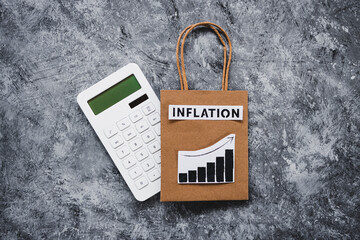 inflation text over shopping bag with graphs showing prices going up