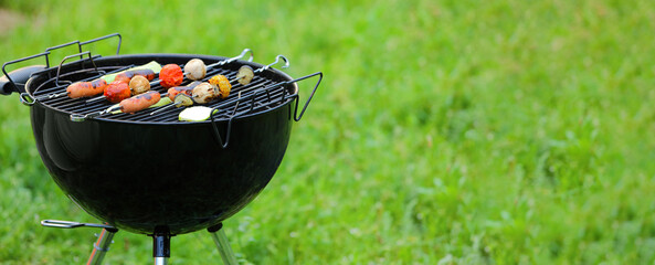 Barbecue grill with tasty sausages and vegetables outdoors - obrazy, fototapety, plakaty