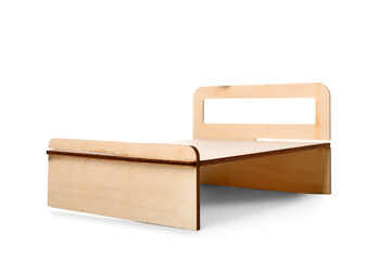 Toy wooden bed on white background