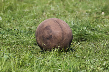 Antique leather ball on green grass