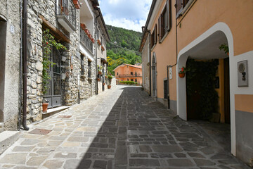 A narrow street between the old houses of Sasso di Castalda, a village in the mountains of Basilicata, Italy.