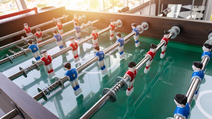 Close-up image of plastic players in a table football game. Table football in the entertainment center. - obrazy, fototapety, plakaty