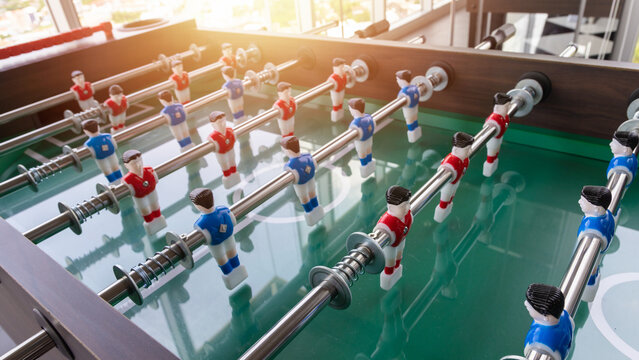 Close-up image of plastic players in a table football game. Table football in the entertainment center.
