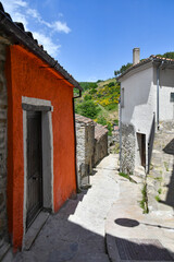 A narrow street between the old houses of Sasso di Castalda, a village in the mountains of Basilicata, Italy.