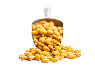 Roasted salted corn snack in scoop isolated on white background.