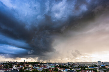 Storm spinning over the city, dramatic storm clouds in Lithuania, Europe