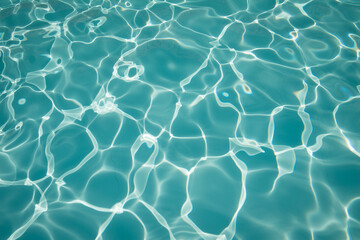 abstract turquoise water background of swimming pool with waves and light reflection