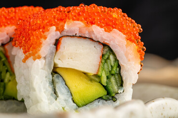 Sushi set of various products on a black stone plate