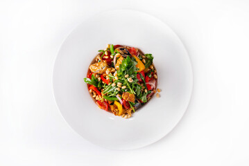 salad with fresh and fried vegetables with nuts and herbs. on a white background