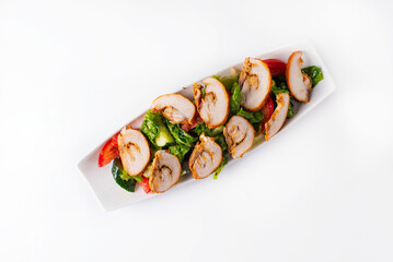 salad of chopped chicken meat with fresh vegetables. on a white background