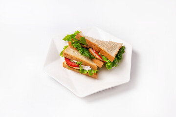 sandwiches with tomatoes, chicken meat, mayonnaise and lettuce leaves. on a white background