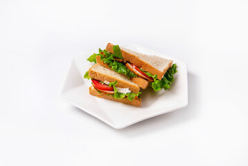 sandwiches with tomatoes, chicken meat, mayonnaise and lettuce leaves. on a white background