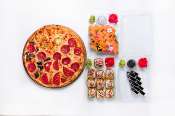 set. assorted pizza with Japanese rolls, dried fruits in plastic containers. on a white background