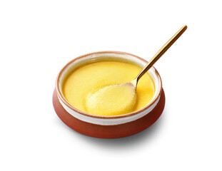 Ghee or clarified butter in a ceramic bowl, spoon full of yellow ghee