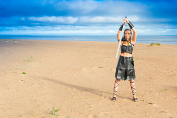 medieval mosstrooper cosplayer wearing leather plastron, skirt, bracelets and rerebrace with...