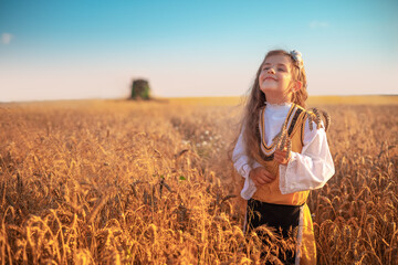 Young girl with traditional Bulgarian folklore costume at the agricultural wheat field during...