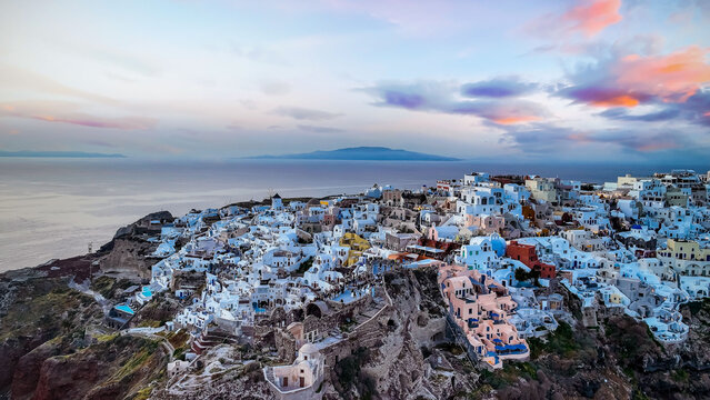 Aerial view with sunset view point of the landmark view in Oia, Santorini. Image of famous village Oia located at one of Cyclades island of Santorini, South Aegean, Greece.