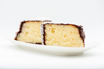 Delectable lamington, made with sponge cake, chocolate sauce and shredded coconut