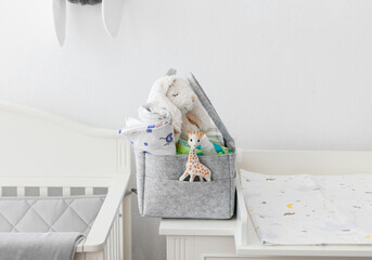 Mothers bag with toy and accessories on white background